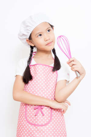 Little Asian cute chef wearing pink apron thinking actionの写真素材