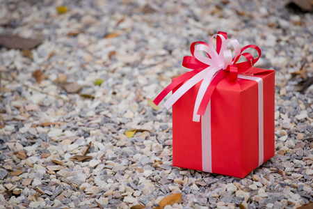 Red gift box on the rockの写真素材