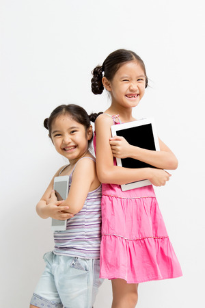Happy Asian child with tablet computerの写真素材