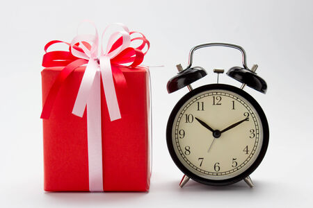 Red gift box and retro alarm clockの写真素材