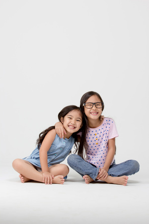 Portrait of little cute Asian girl on isolated backgroundの写真素材