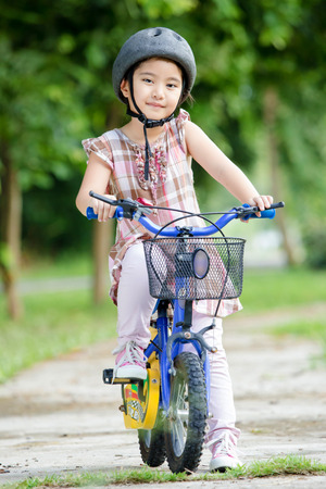 Little Asian child with bicycleの写真素材