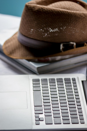 Sun hat and laptop on the bed, travel conceptの写真素材