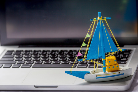 Toy Ship on the laptopの写真素材
