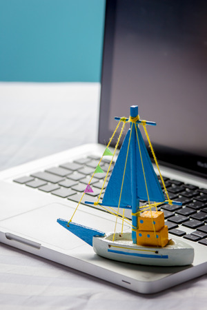 toy ship on the laptopの写真素材