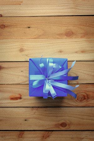 Blue gift box for new year on wooden backgroundの写真素材