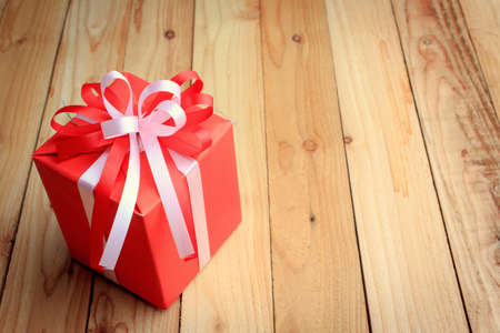 Red gift box for new year on wooden backgroundの写真素材