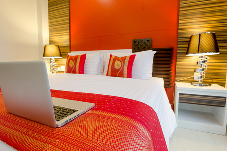 Labtop on the bed, oriental style apartment Service Room at Patong Beach Phuket, Thailandの写真素材