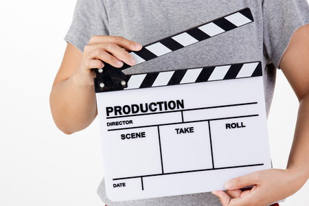 Asian woman holding movie production clapper board on white backgroundの写真素材