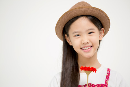 Portrait of happy little Asian child smiling on isolated backgroundの写真素材