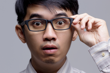 Close up of Asian businessman surprised faceの写真素材