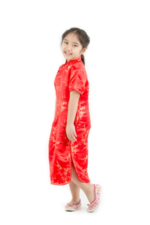 Happy Asian Chinese child dressing Chinese traditional dress on isolatedの写真素材
