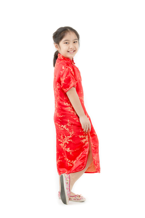 Happy Asian Chinese child dressing Chinese traditional dress on isolatedの写真素材