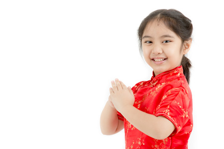 Little Asian girl wishing you a happy Chinese new year on isolatedの写真素材