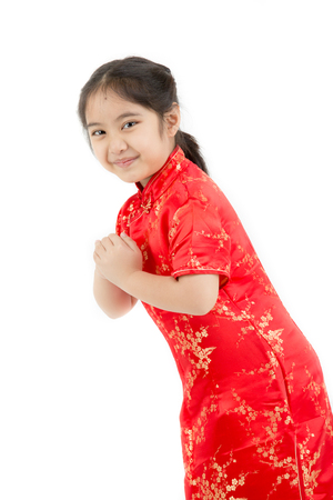 Little Asian girl wishing you a happy Chinese new year on isolatedの写真素材