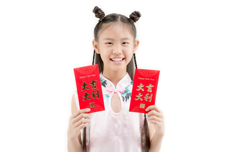 Happy Asian Chinese child showing Chinese new year red paper packet gift on isolatedの写真素材