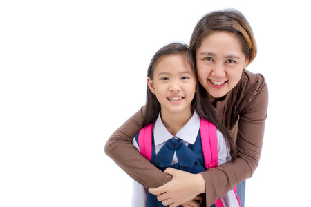 Portrait of asian child in school uniform hugging with mother on white background isolatedの写真素材