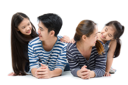 Asian family smiling and lying on isolated white background, Happy familyの写真素材