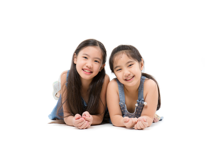 Portrait of happy little cute Asian girl smiling isolated over white backgroundの写真素材