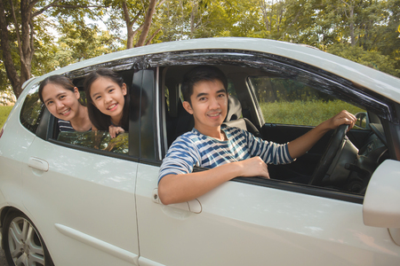 Happy Asian family on van are smiling and driving for travel on vacationの写真素材
