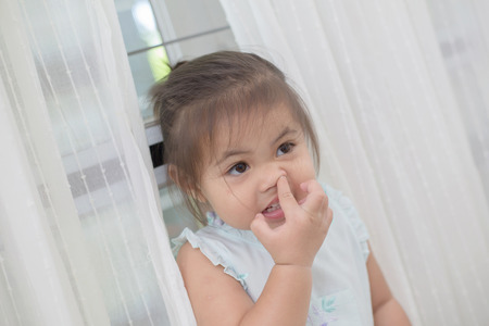 Little Asian girl picking her boogersの写真素材