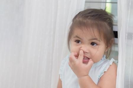 Little Asian girl picking her boogersの写真素材