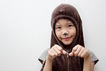 Portrait of cute girl in Halloween costume looking at cameraの写真素材
