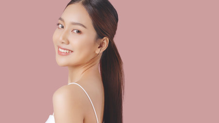 Studio shot of Beautiful young Asian woman with clean fresh skin on pink background, Face care, Facial treatment, Cosmetology, beauty and spa.の写真素材