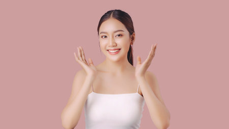Studio shot of Beautiful young Asian woman with clean fresh skin on pink background, Face care, Facial treatment, Cosmetology, beauty and spa.の写真素材