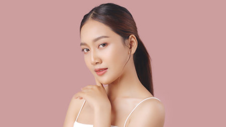 Studio shot of Beautiful young Asian woman with clean fresh skin on pink background, Face care, Facial treatment, Cosmetology, beauty and spa.の写真素材