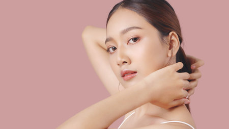 Studio shot of Beautiful young Asian woman with clean fresh skin on pink background, Face care, Facial treatment, Cosmetology, beauty and spa.の写真素材