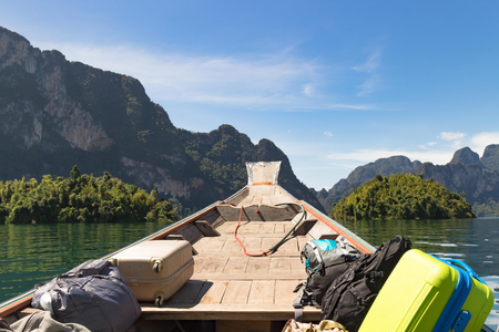 Tourist luggages and bags has been transporting by boat to the resorts on the water inside the lake...