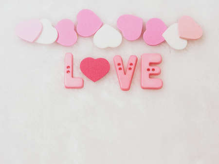 Valentines day background, word love and heart on white wool backgroundの写真素材