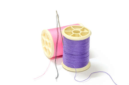 Purple thread and Pink thread and Needle with black thread