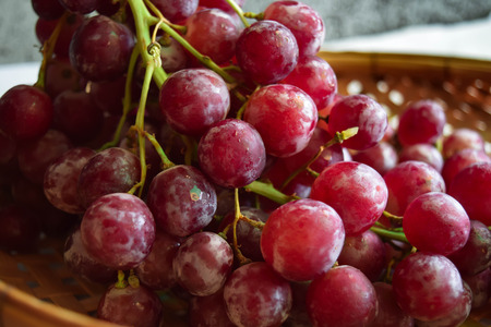 red grapes in basket weaveの写真素材