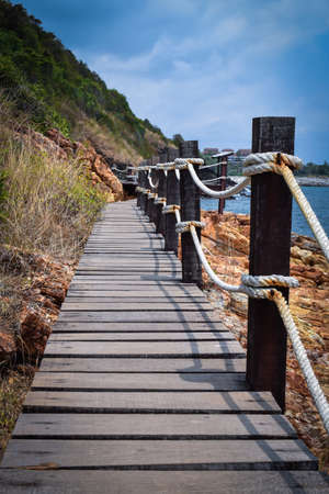 wood bridge sea and mountainの写真素材