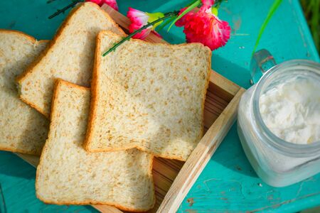 morning time milk and whole wheat bread in gardenの写真素材