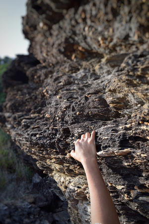 hand climbing on rock mountainの写真素材