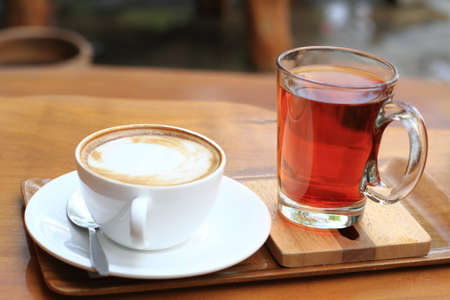 Cup of mocha coffee and glass of  tea の写真素材