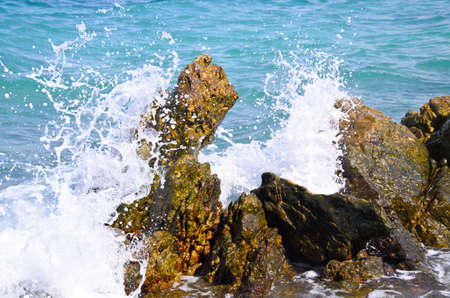 Waves breaking on the rocksの写真素材