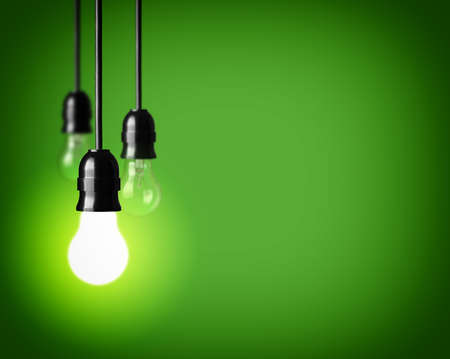 Light bulbs on green background の写真素材