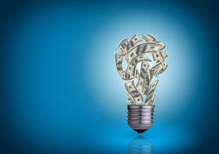 light bulb with money banknotes inside it on blue backgroundの写真素材