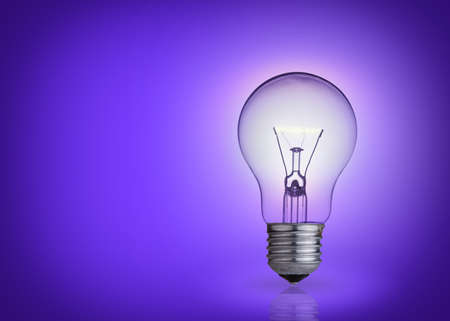 light bulb on purple background の写真素材