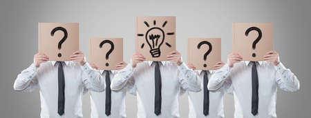 businessmen holding a card on head の写真素材