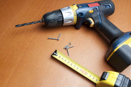 drill with roulette on wooden below 