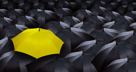 many blacks umbrellas and one yellow umbrella の写真素材