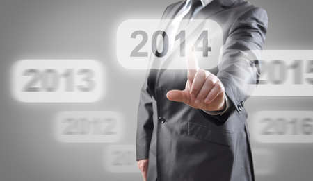Businessman selects 2014 on touch screenの写真素材