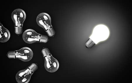Idea concept with light bulbs, one of them is glowing 