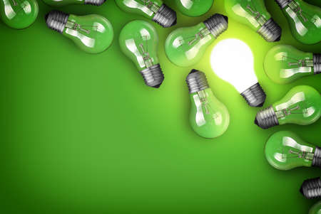 Idea concept with light bulbs on green backgroundの写真素材