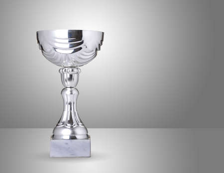champion silver trophy over grey backgroundの写真素材